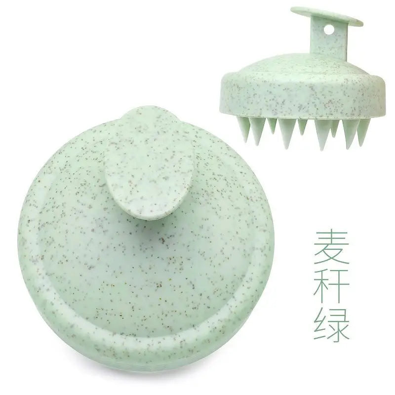 Silicone scalp massage brush comb in a green color, designed for head massages and hair care.